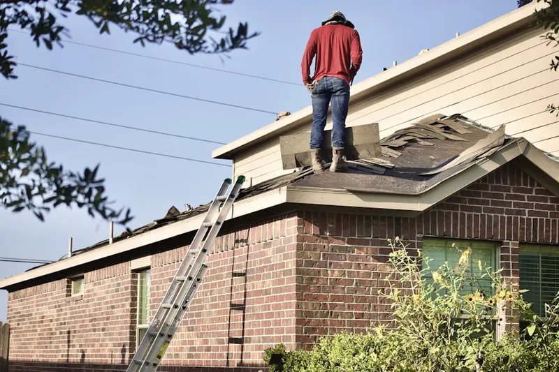 Professional roofer working on a residential roof in Lake Awesome